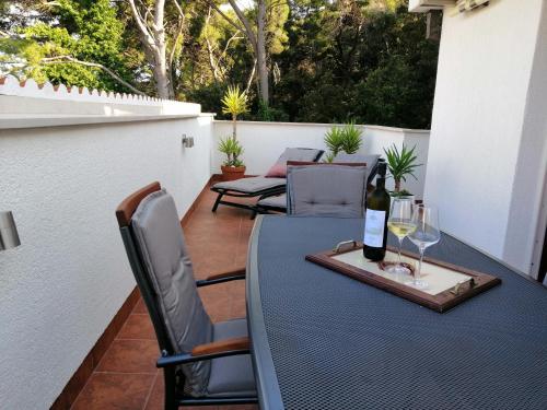 a bottle of wine on a table on a patio at Apartment Markorcula in Korčula