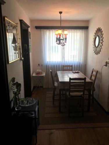 a dining room with a table and chairs and a window at TOP LOCATION - Klosters center - 130m distance to ski lift Parsenn Gotschnabahn and railway station Klosters Platz - direct connection to Davos in Klosters