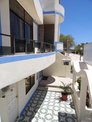 a balcony of a house with a tile floor at Hostal Cerro Azul in Puerto Villamil