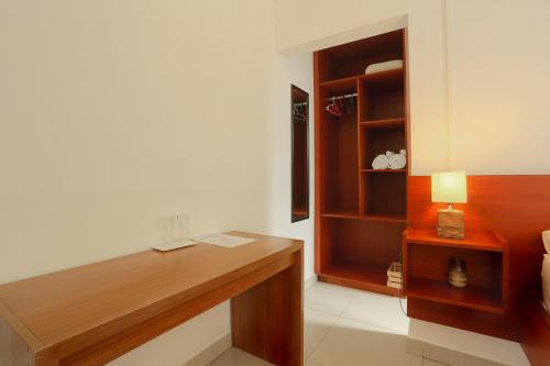 a room with a desk and a book shelf at Auberge SeaFever in Mahébourg