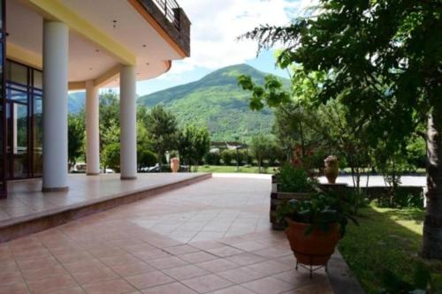 a porch of a building with a mountain in the background at Gea Kaimaktsalan Hotel & Spa in Kato Loutraki