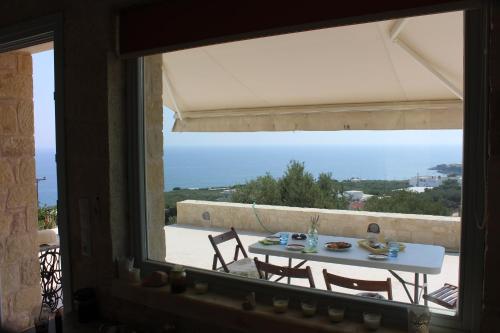 a view of a table and chairs from a window at Villa Bianca in Ferma