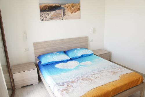 a bedroom with a bed with two pillows on it at Apartment Mistral in Badesi