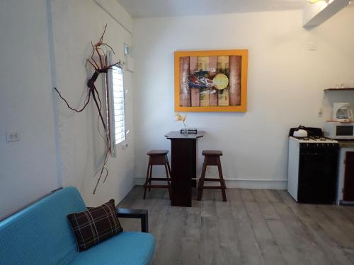 a living room with a blue couch and a table at Simberts Apartments in Maya Beach