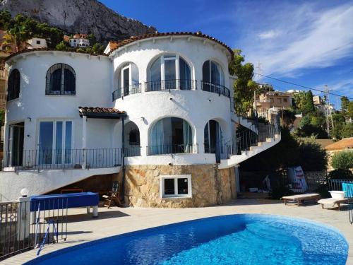a house with a swimming pool in front of it at villa Grace,10p,seaview,pool in Calpe