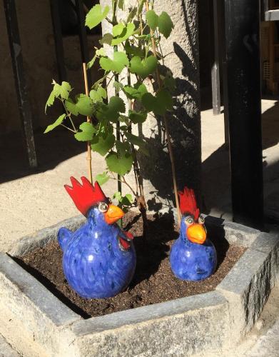 two blue birds sitting next to a tree at Ca' di Pincia in Astano