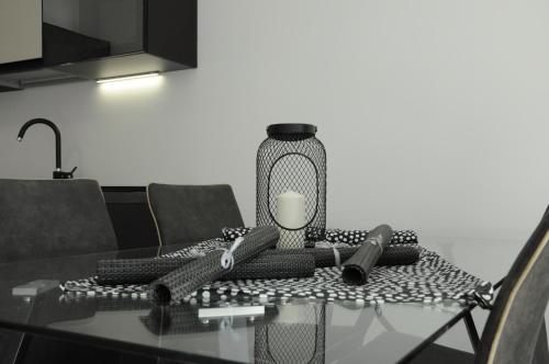 a glass table with a lamp on top of it at Casa Guarnati Lake View Apartments in Malcesine
