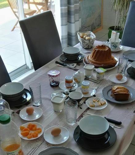 a table with plates of food on top of it at Le Hameau du moulin a vent in Saint-Avertin