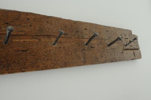 a piece of wood with nails sticking out at Casa Guarnati Lake View Apartments in Malcesine