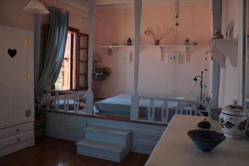 a bedroom with a canopy bed and a table at Astradeni in Symi