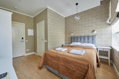 a bedroom with a bed with two towels on it at Rohuaia Apartments in Rakvere