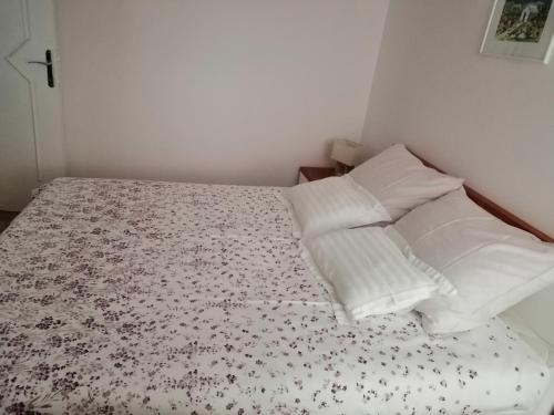 a bedroom with a bed with white pillows at Apartment Markorcula in Korčula