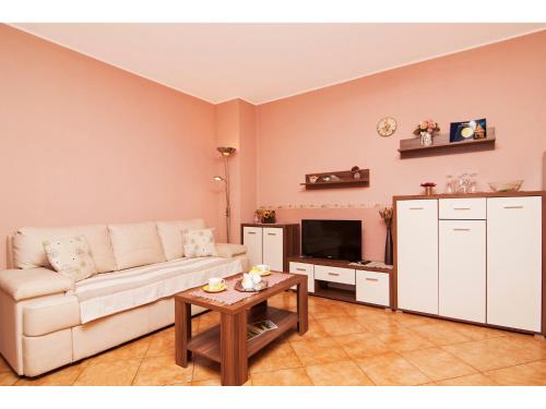 a living room with a couch and a table at Apartman Nensi in Vodnjan