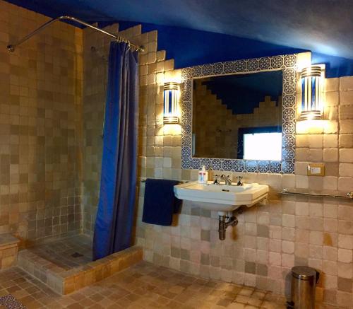 a bathroom with a sink and a mirror at VILLE GIRASOLI "VILLA NELLA BAIA" with PRIVATE SWIMMING POOL in Tricase