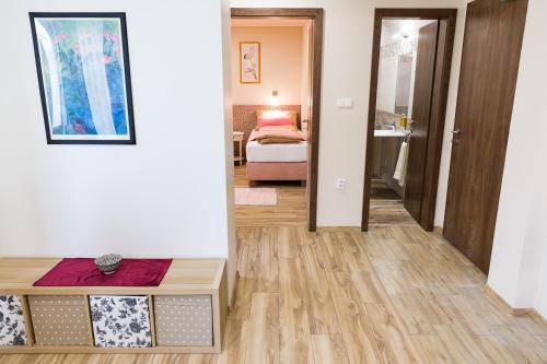 a hallway with a bedroom and a bed in a room at SoleGutta in Kolárovo