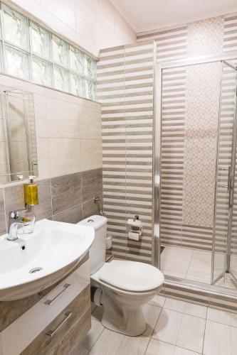 a bathroom with a toilet and a sink and a shower at SoleGutta in Kolárovo