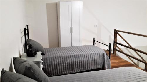 a living room with two beds and a staircase at POMPEI VESEVUS APARTAMENT in Boscotrecase