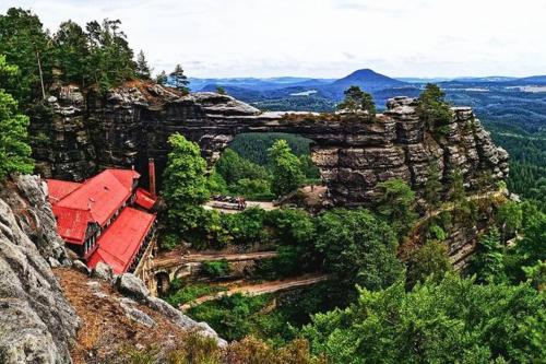 a house on top of a mountain with a bridge at Krásný byt v centru Děčína in Děčín