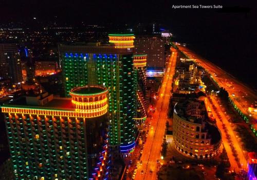 an aerial view of a city at night at Sea Towers Suite in Batumi