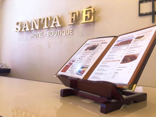 a menu on a table in a restaurant at Santa Fe Hotel Boutique in Tapachula