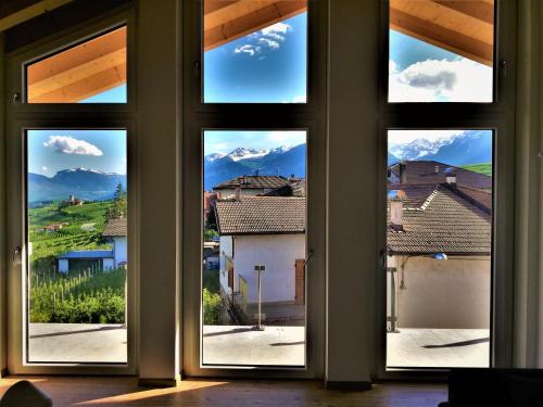 an open window with a view of a city at Orizzonti d'Anaunia in Tassullo