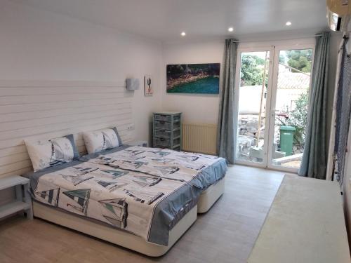 a bedroom with a bed and a large window at villa Grace,10p,seaview,pool in Calpe
