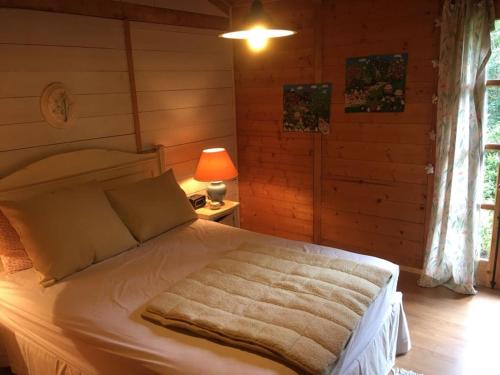 a bedroom with a bed with a blanket on it at Huincaterra in Villarrica