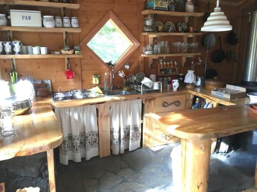 a kitchen with a wooden counter and a table at Huincaterra in Villarrica