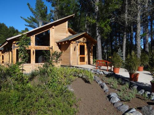 a log cabin with a bench in front of it at Huincaterra in Villarrica