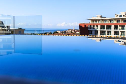a swimming pool with a view of a building at Hotel Fagus by Aycon in Budva