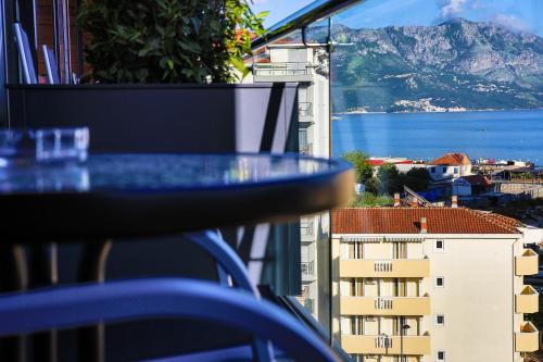 a table with a view of the ocean and buildings at Hotel Fagus by Aycon in Budva