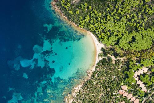 an aerial view of a beach and the ocean at Hotel il Faro di Molara in Porto San Paolo