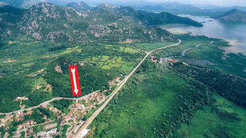 a red spot on top of a mountain with a road at Guest House Luna in Virpazar