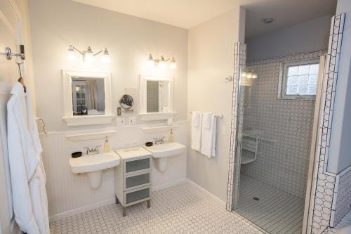 a white bathroom with a sink and a shower at The Inn on First in Napa
