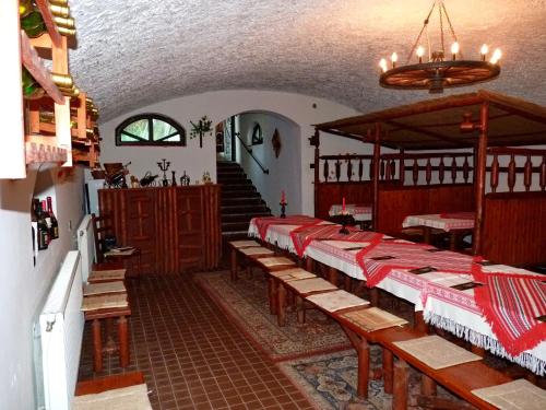 a room with rows of tables and a staircase at Gedeon Tanya Panzió in Jakabszállás