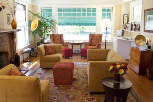 a living room with couches and chairs and a fireplace at The Inn on First in Napa