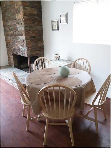 a dining room with a table and chairs and a fireplace at 25 Steps to the Beach in Newport Beach