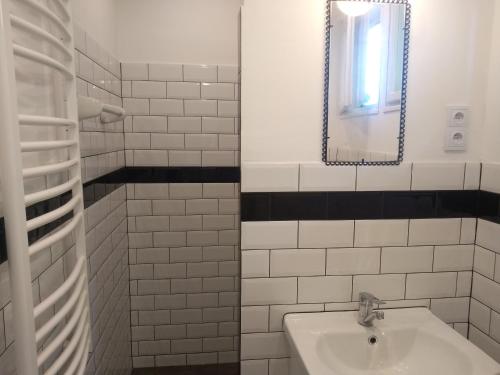 a white bathroom with a sink and a mirror at Willa Wiślok in Wisła