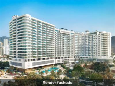 a large building with a pool in front of it at Apartamentos Reserva del Mar in Santa Marta