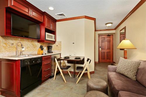 a kitchen and living room with a couch and a table at Condos at Canyons Resort by White Pines in Park City