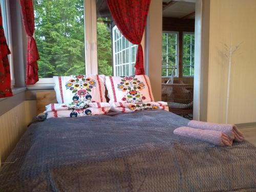 a bedroom with a bed with pillows and a window at Willa Wiślok in Wisła