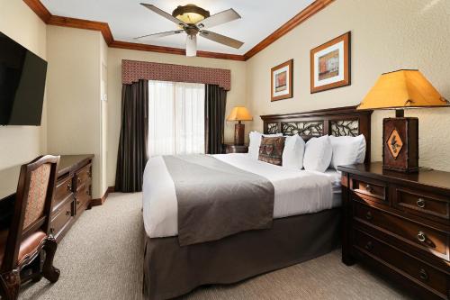a bedroom with a large bed and a television at Condos at Canyons Resort by White Pines in Park City