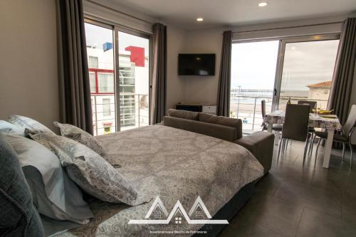 a bedroom with a bed and a view of the ocean at White House I in Praia da Vitória