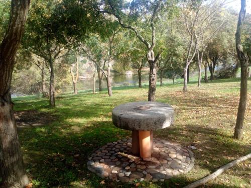 a stone bench sitting in the middle of a park at Casas do Ardila in Santo Amador