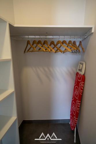 a closet with a red snowboard in it at White House II in Praia da Vitória
