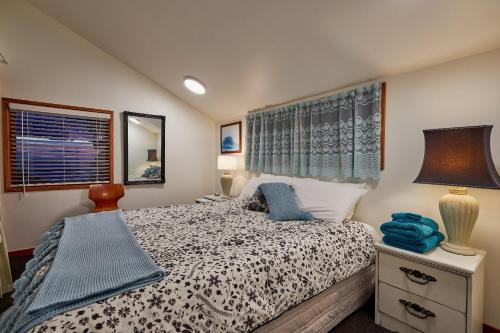 a bedroom with a bed and a lamp and a window at A Room With a View in Kaikoura