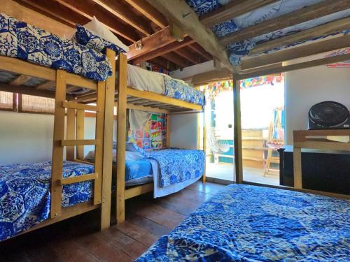 a bedroom with two bunk beds and a balcony at Mancora Apartments in Máncora