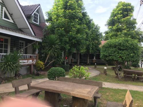 a wooden bench in front of a house at The Green land (Khok Kruat) in Nakhon Ratchasima