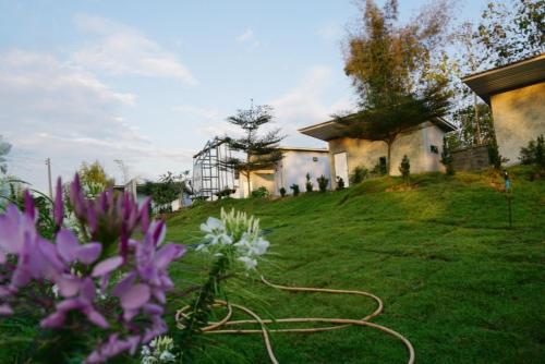 a house on a hill with a hose in a yard at Chill loft โฮมเสตย์ in Nan