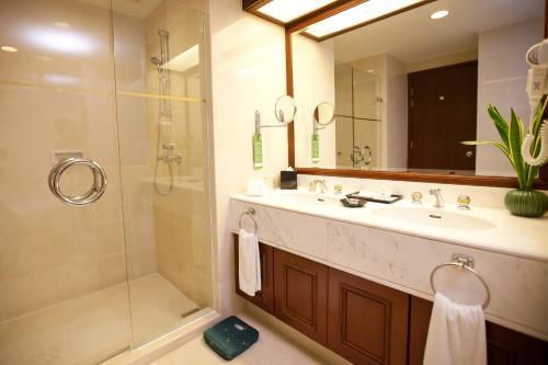 a bathroom with a sink and a shower at Evergreen Laurel Hotel Penang in George Town